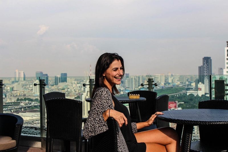 Woman smiling checking the view of the hotel Amari Watergate Bangkok.
