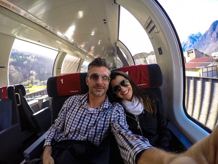 A couple traveling by train in Europe. They are happy because they are traveling with Eurail Pass.