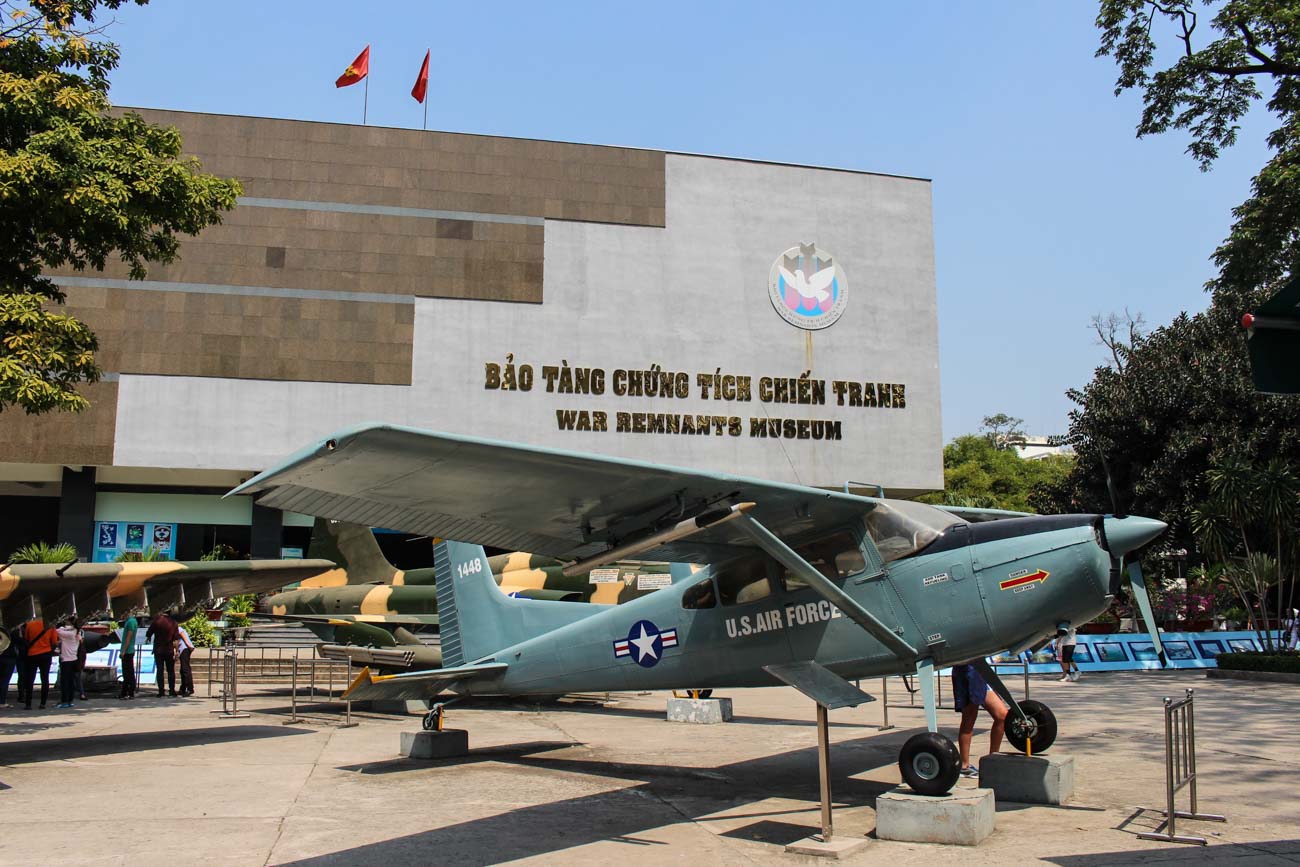 Photo of the War Museum in Vietnam. The building faced with an old airplane in front of it.