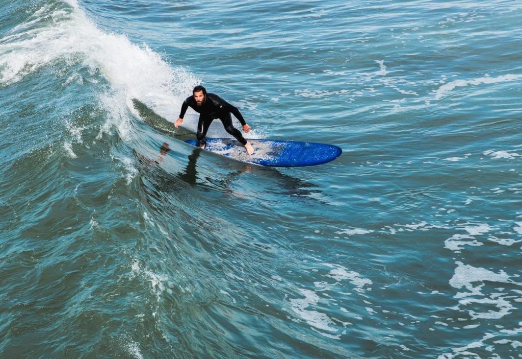 Surfer at La Jolla Shores Beach, which is one of the best places to take surf lessons in San Diego.