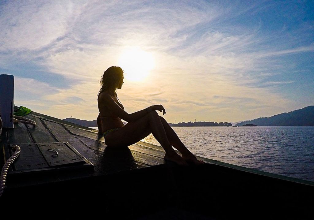 Woman looking at the ocean on a boat going to Koh Lipe, Thailand.