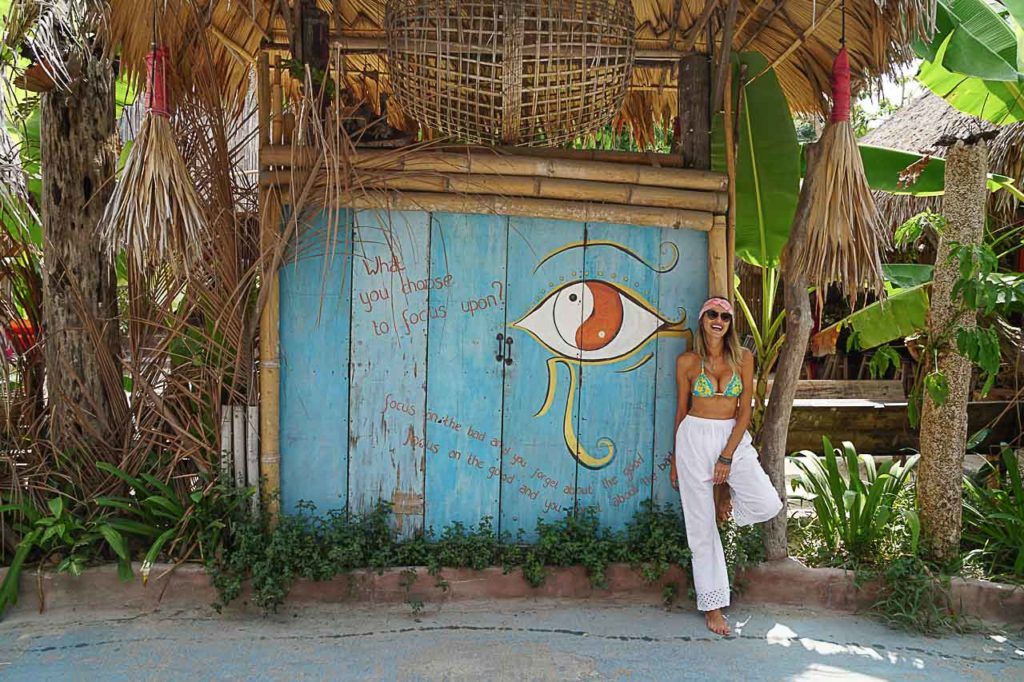Woman posing in front of a hotel in Koh Lipe, Thailand.