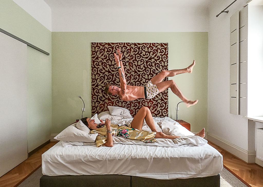 Couple on the bed happy jumping.