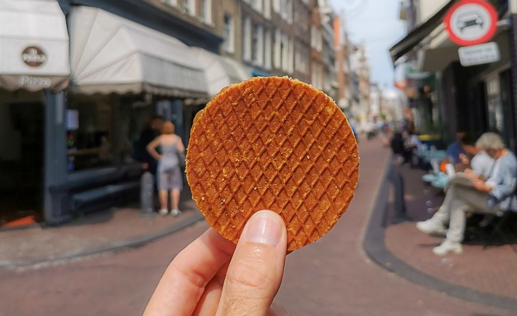A stroopwafel in the streets of Amsterdam. Find here all the information you need to know about your Amsterdam trip budget.