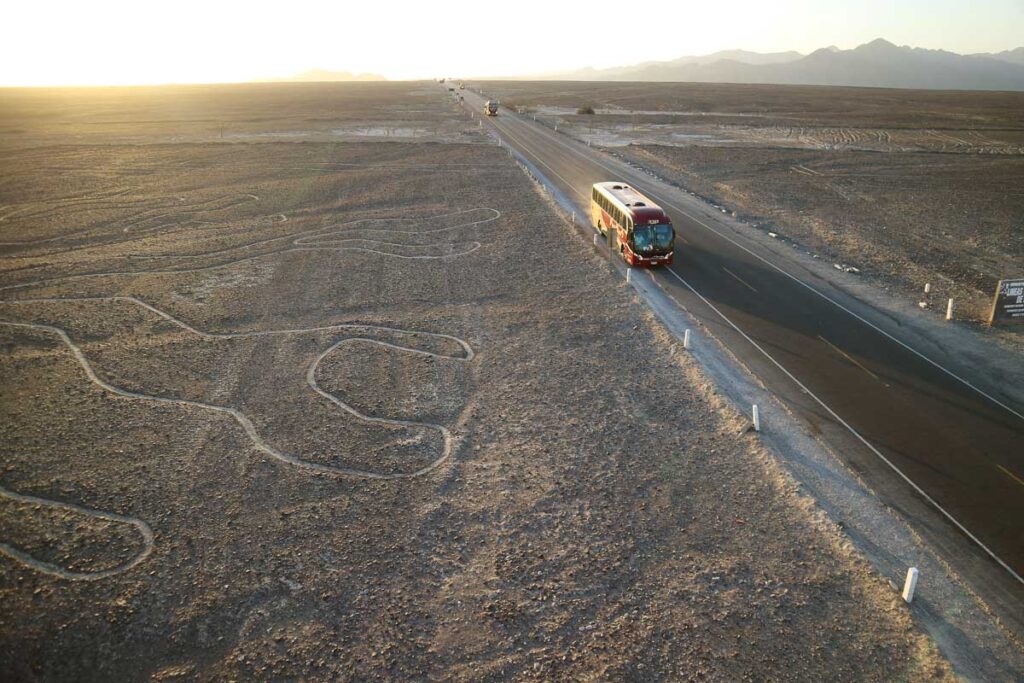 Quickly cut through the famous great ancient geoglyphs Nazca lines as seen from the lookout tower, Nazca Desert of Peru