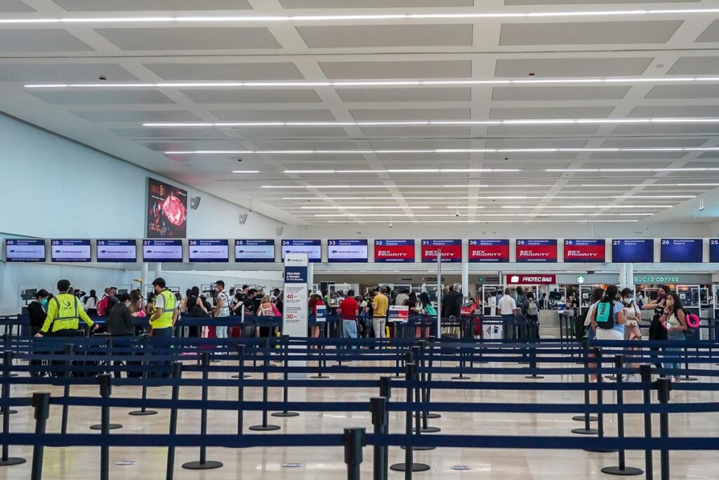 People queuing at Cancun Airport waiting for their transportation from Cancun Airport to Playa del Carmen. 