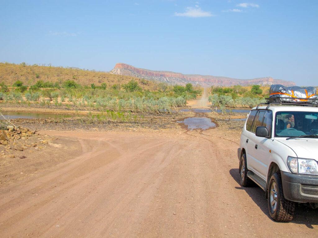Photo of a car making a road trip in Western Australia, through the Gibb River Road.
