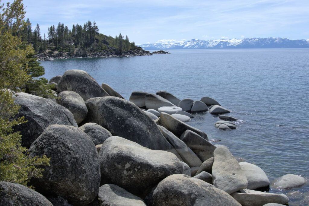 Lake Tahoe with snow-capped mountains in the background. It illustrates some of the best hikes in Northern California