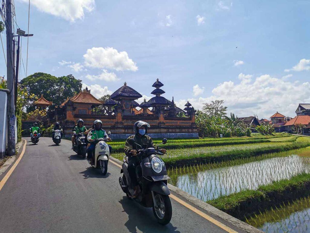 Motorbikes and scooters on a narrow road in Canggu, Bali.