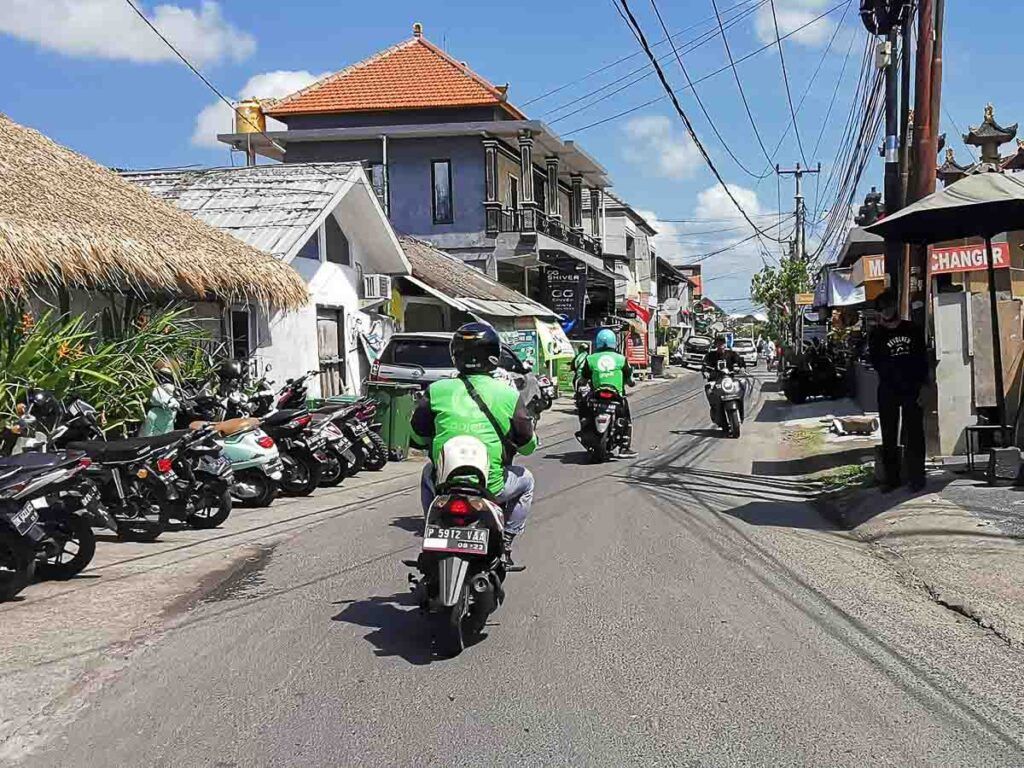 Photo of a GoJek motorbike taxi driving in Canggu streets. 