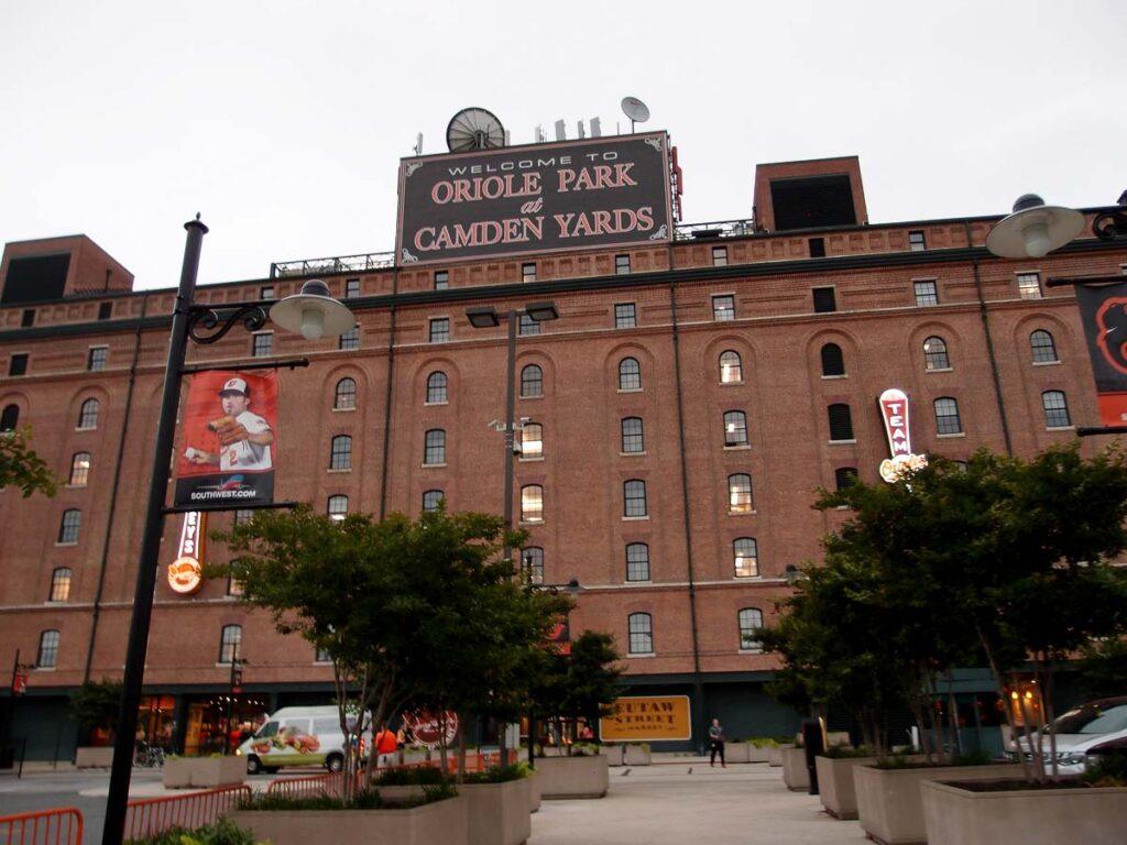 Welcome to Oriole Park at Camden Yards sign atop Ballpark during baseball game. 