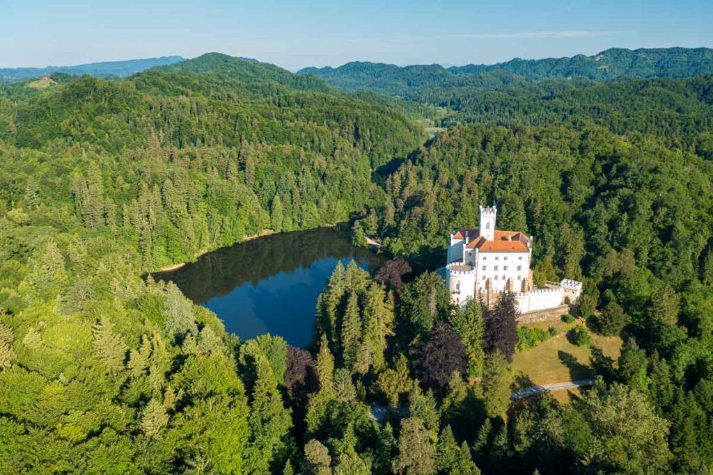 Trakošćan Castle, Zagorje, is a magnificent place in Croatia. The photo shows the castles on top of the hill surrounded by forest, such a hidden gem in Croatia.
