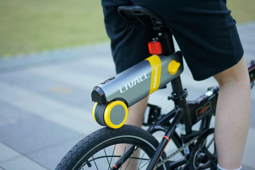Photo of a PikaBoost e-bike kit installed in a foldable bike. It shows how small this device is. 