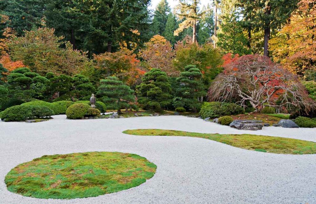 Portland Japanese Garden section flat garden, raked white sand represents water and vividly contrasts with lawn, moss, evergreens and azaleas. It's one more fun things to do in Portland for adults.