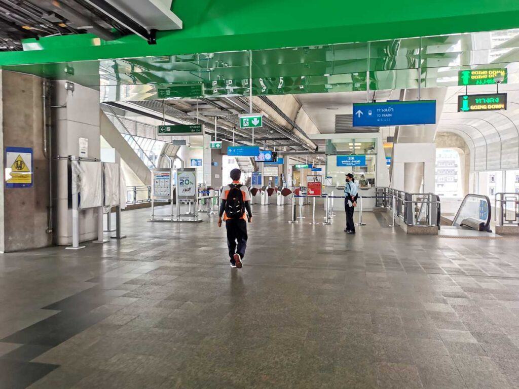 Man walking at the entrance of Skytrain station in Bangkok. The public transportation in Bangkok is clean, safe and well-organized.  
