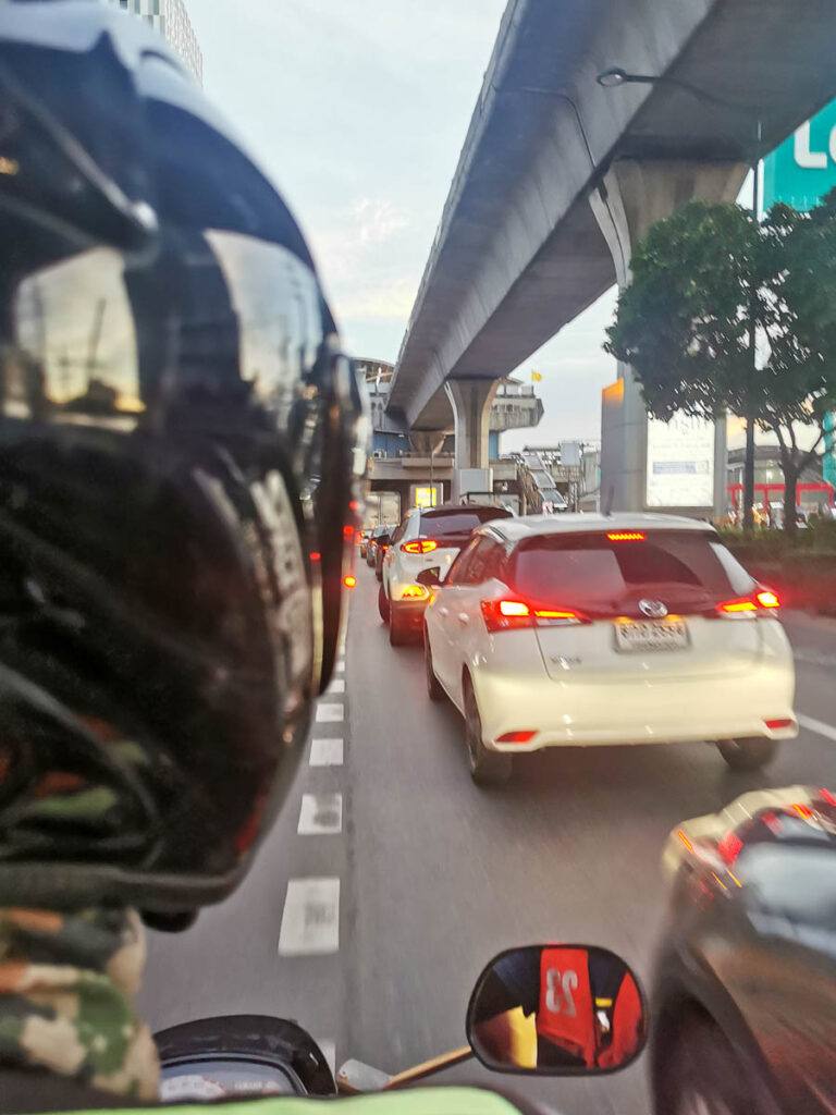 Photo of a motorbike in city center in the middle of a traffic jam.