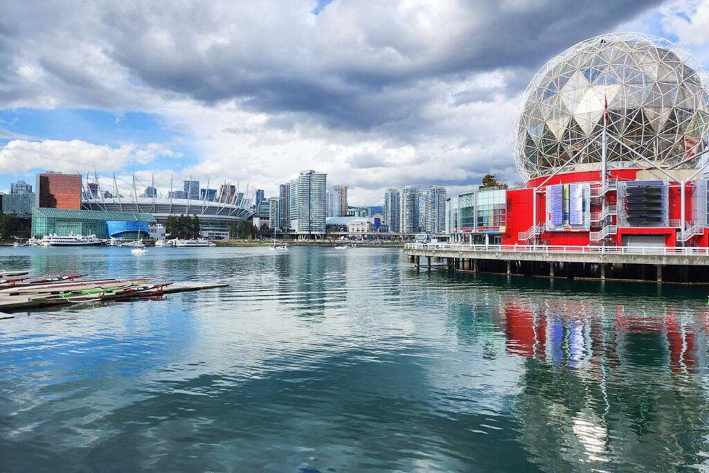The photo of False Creek in Vancouver shows the Science World museum on one side and the downtown skyline on the other.