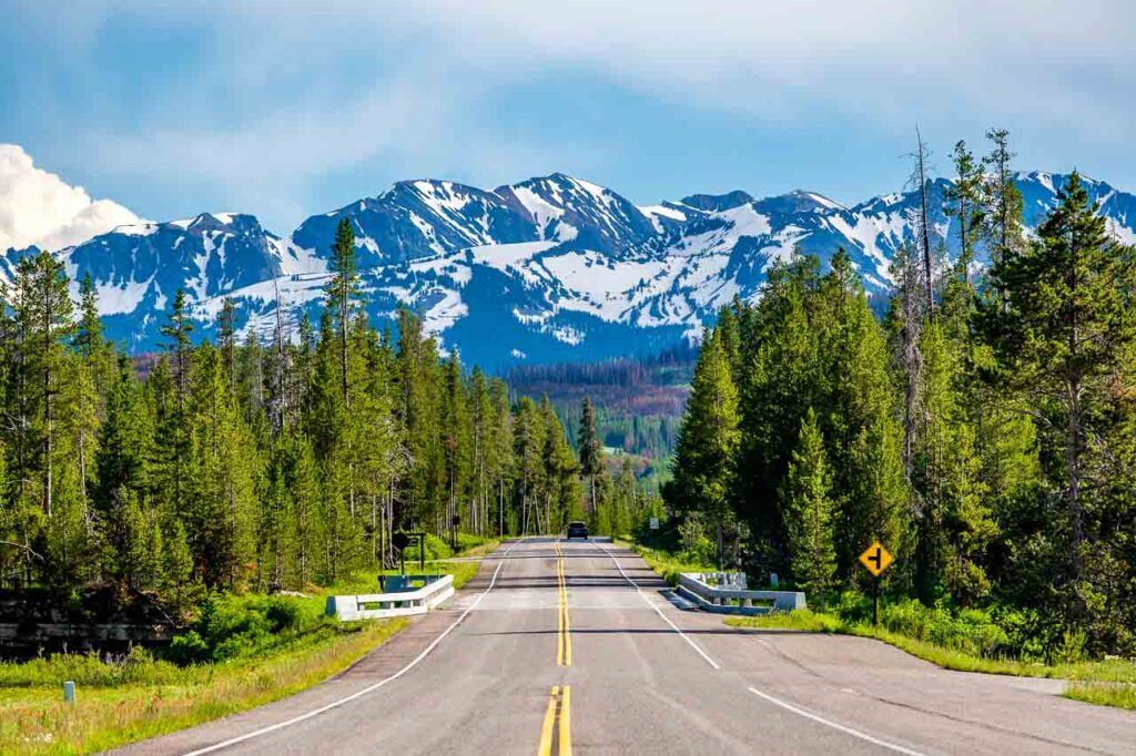 The road from Yellowstone National Park to Grand Teton National Park in Wyoming, USA. These to parks should be on your west coast road trip.