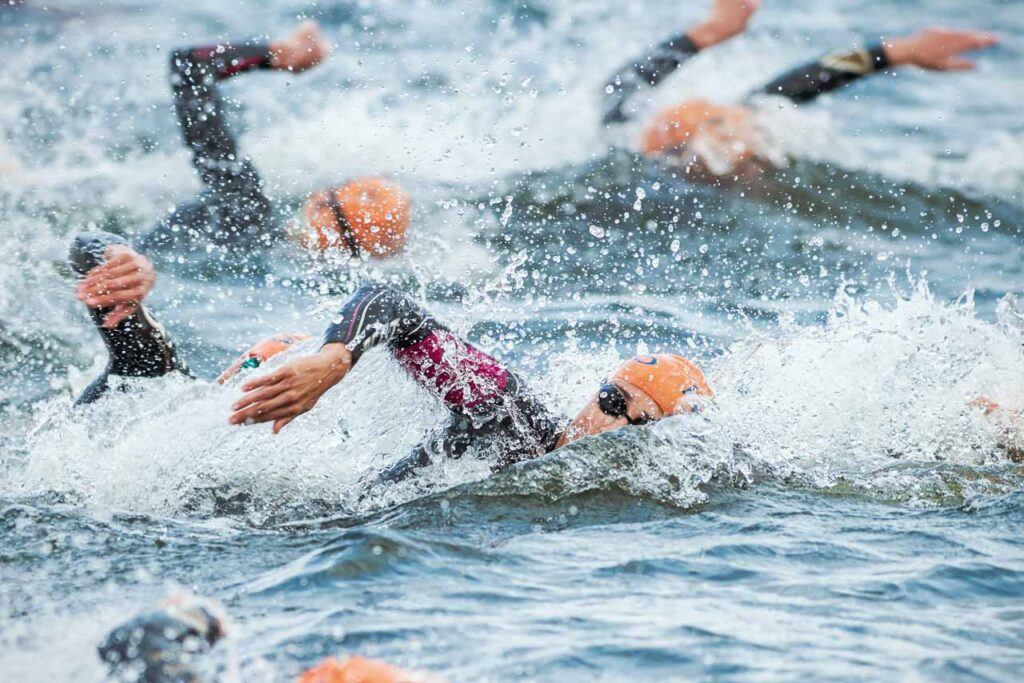 Triathletes swimming during an Ironman competition in Europe.