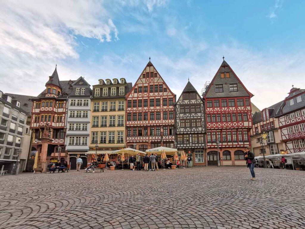 Photo of Frankfurt's old town. It shows the old square with historical buildings and a few cafes for tourists visiting Frankfurt, Germany.