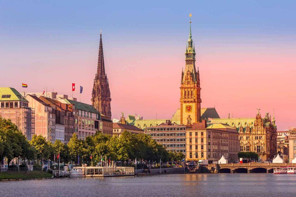 Hamburg, Germany colorful pink sunset view of city center with town hall and Alster Lake. Here is where it will happen Ironman Hamburg competition.