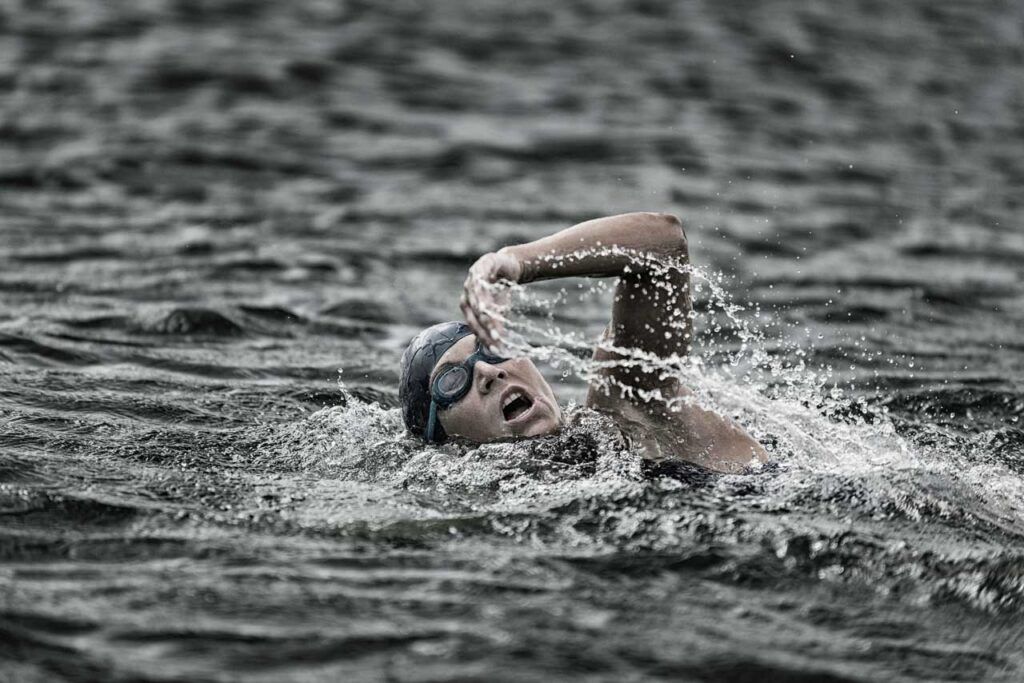 Female athlete swimming in a triathlon competition in the UK. Bolton Ironman is the only full-distance triathlon in England. 