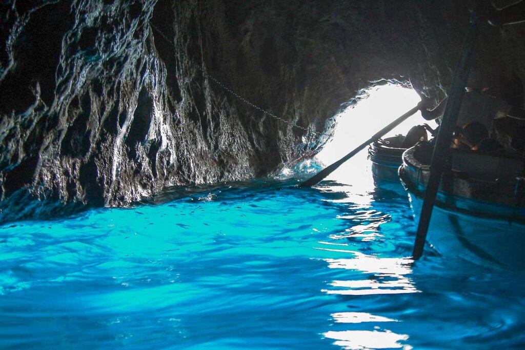 A boat carrying tourists in Blue Cave in Capri, Italy.