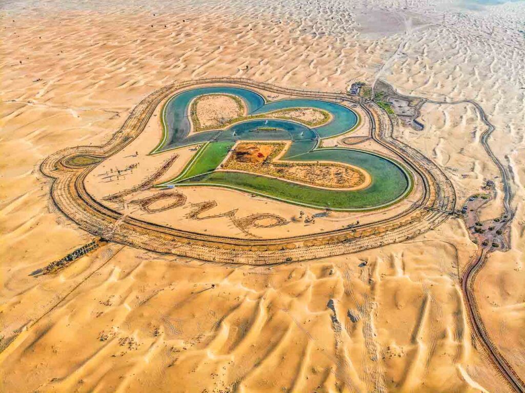 An aerial view of Dubai desert with two lakes shaped as hearts in Al Qdra Lakes in Dubai.