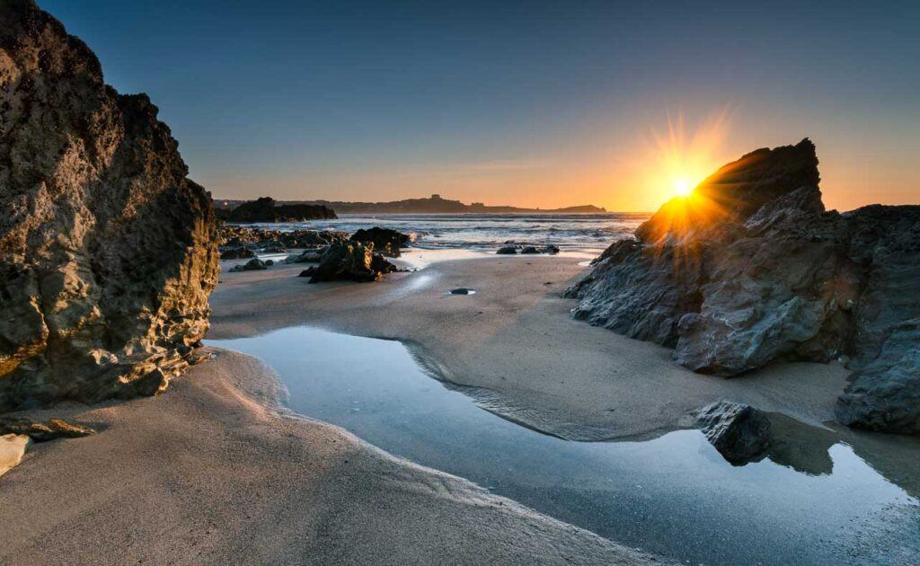 Sunset on Lusty Glaze Beach at Newquay in Cornwall.