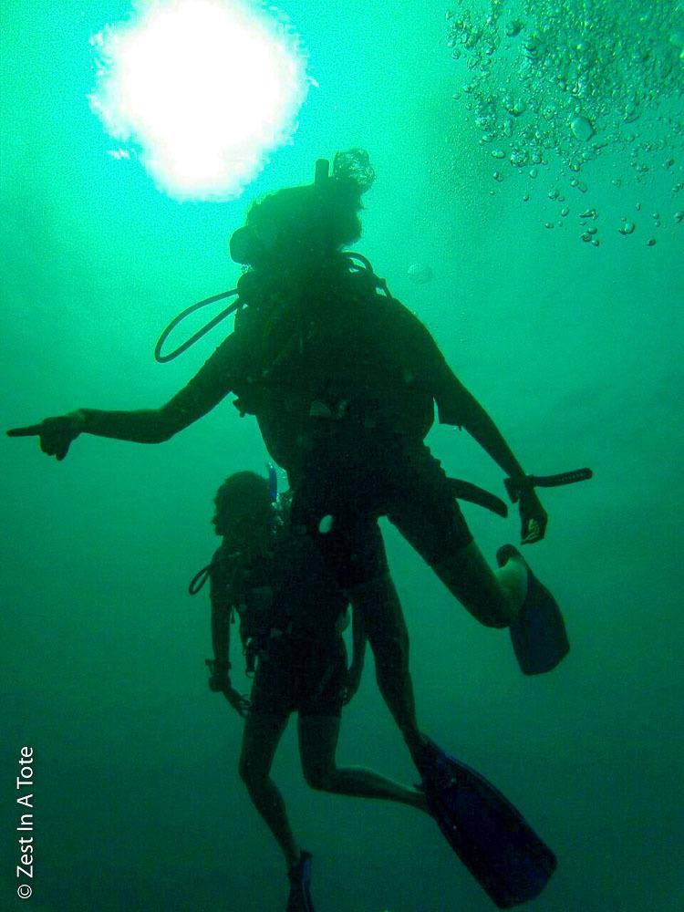 Two people underwater learning how to scuba dive in Andaman Islands India. 