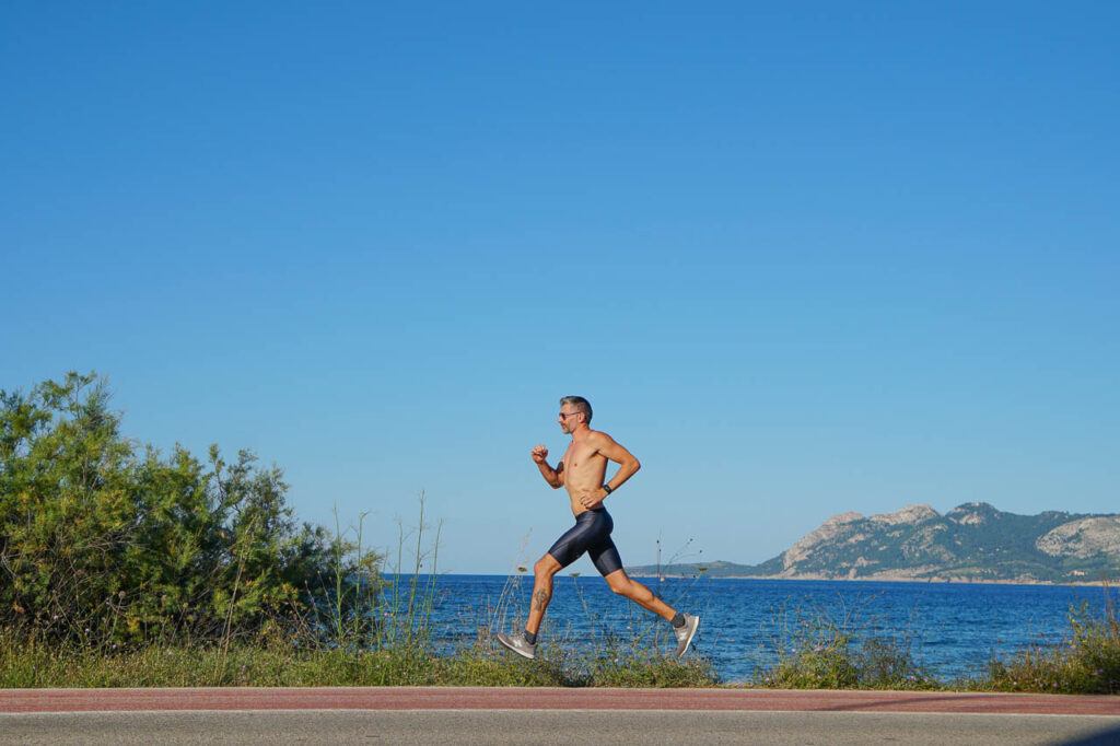 A man running in Mallorca, near the town of Alcudia where it will happen the Ironman 70,3 Mallorca.
