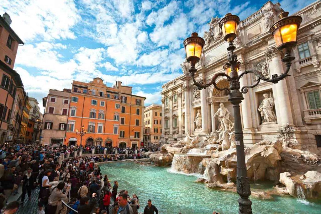 Tourists visiting the Trevi Fountain in Rome, Italy. Trevi Fountain is among the most iconic fountains in the world and one of Italy's top attractions.