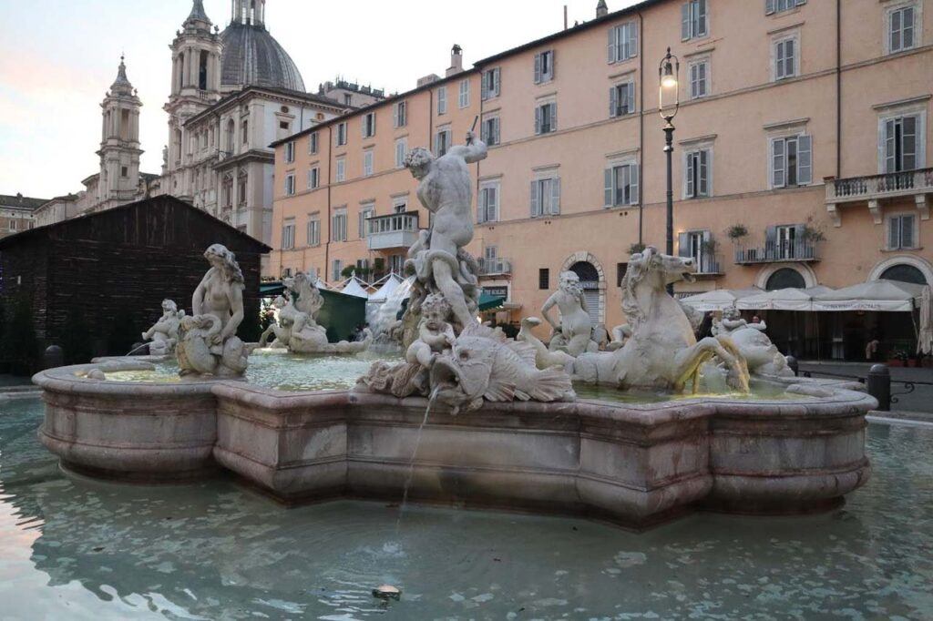 Photo of Piazza Navona in Rome, Italy. It shows the Fontana dei Quattro Fiumi and baroque building in the background.