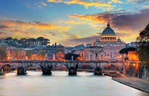 Photo of sunset over the river and Vatican City in Rome, Italy.